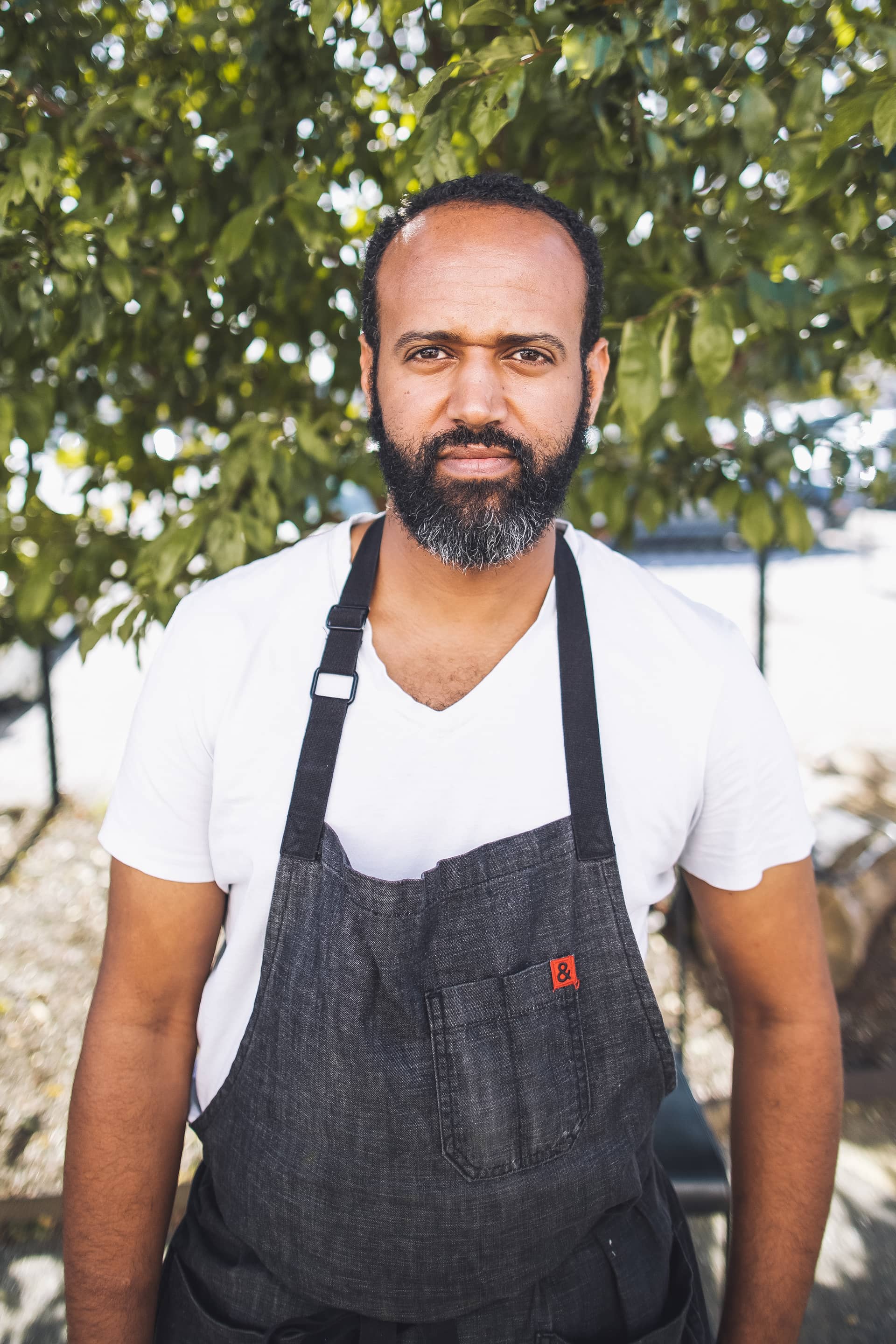 Chef Elias headshot · working apron portrait