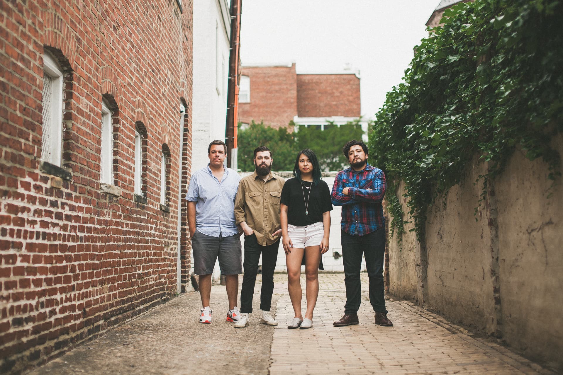 The 2016 Workhorse team, four members, standing in the brick alley behind the carriage house.