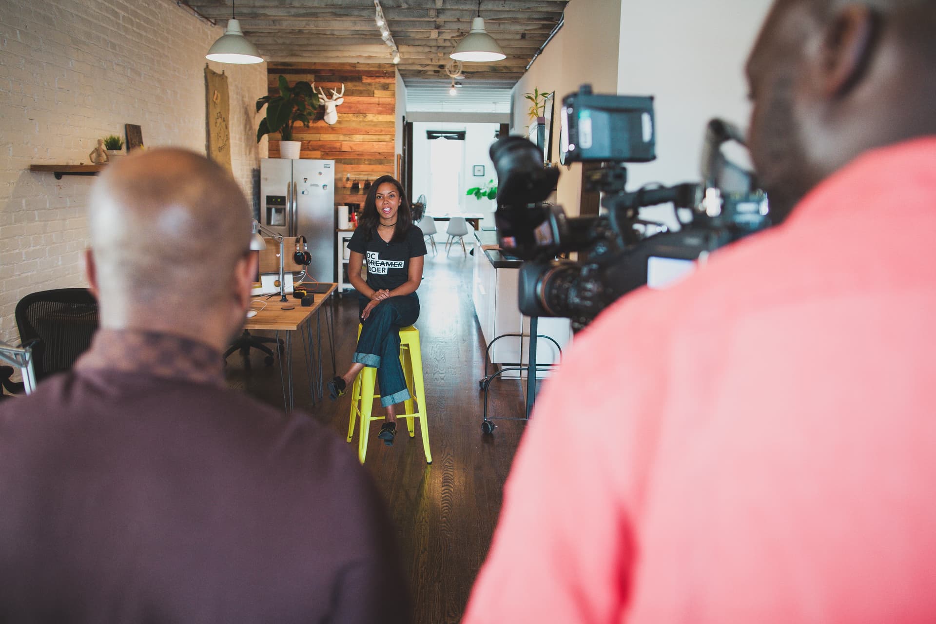 Wide of the studio interior with camera setup against the brick.