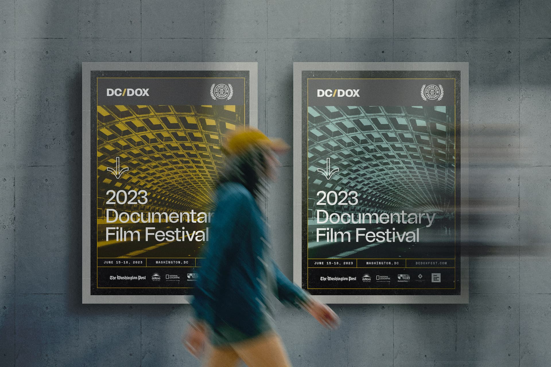Two DC/DOX 2023 festival posters on a gray wall with a passerby