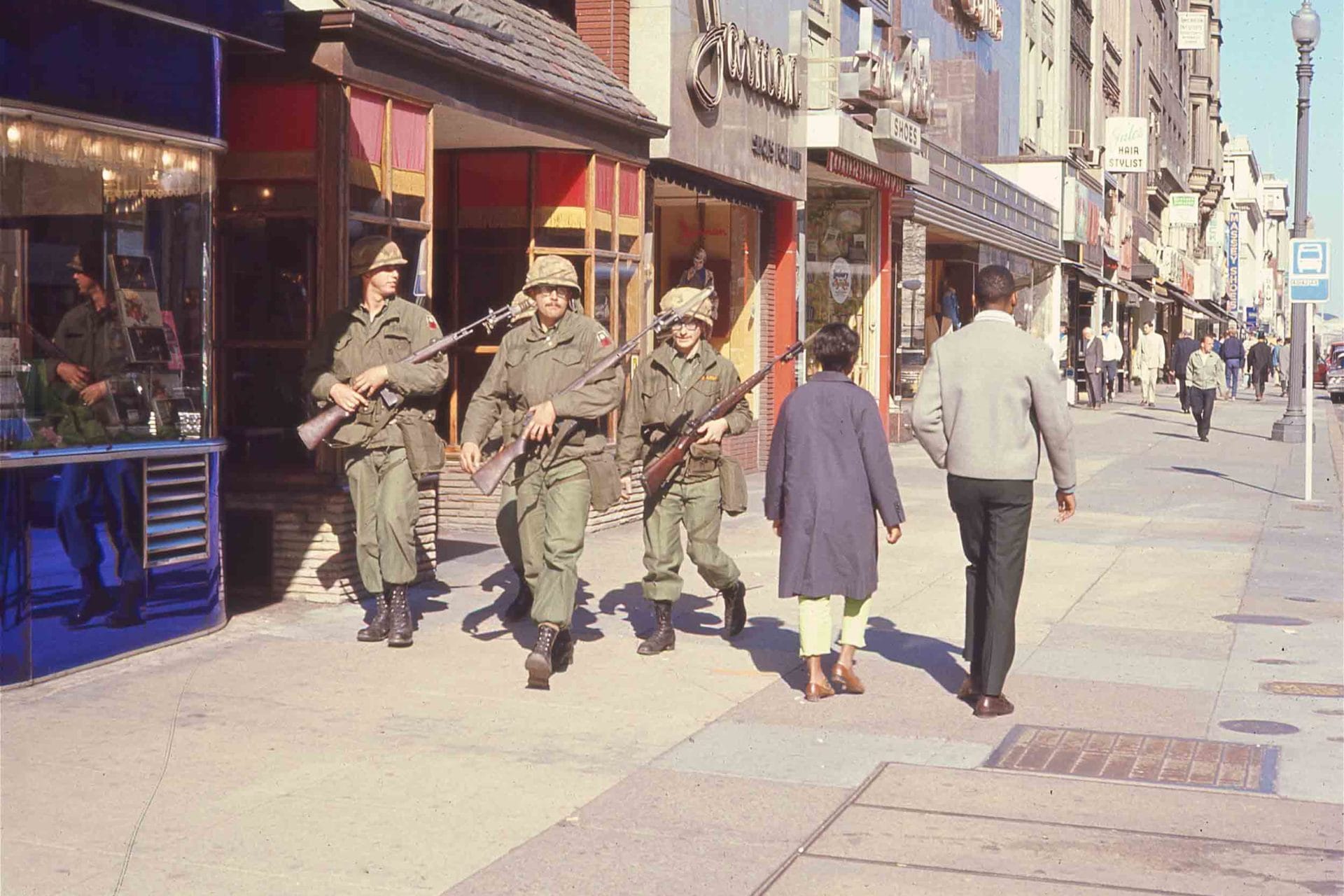 Troops walking a District sidewalk during the 1968 uprising