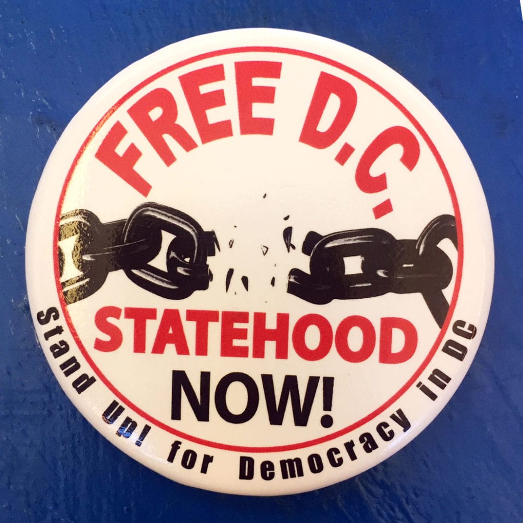 A Free DC, Statehood Now button with a broken chain