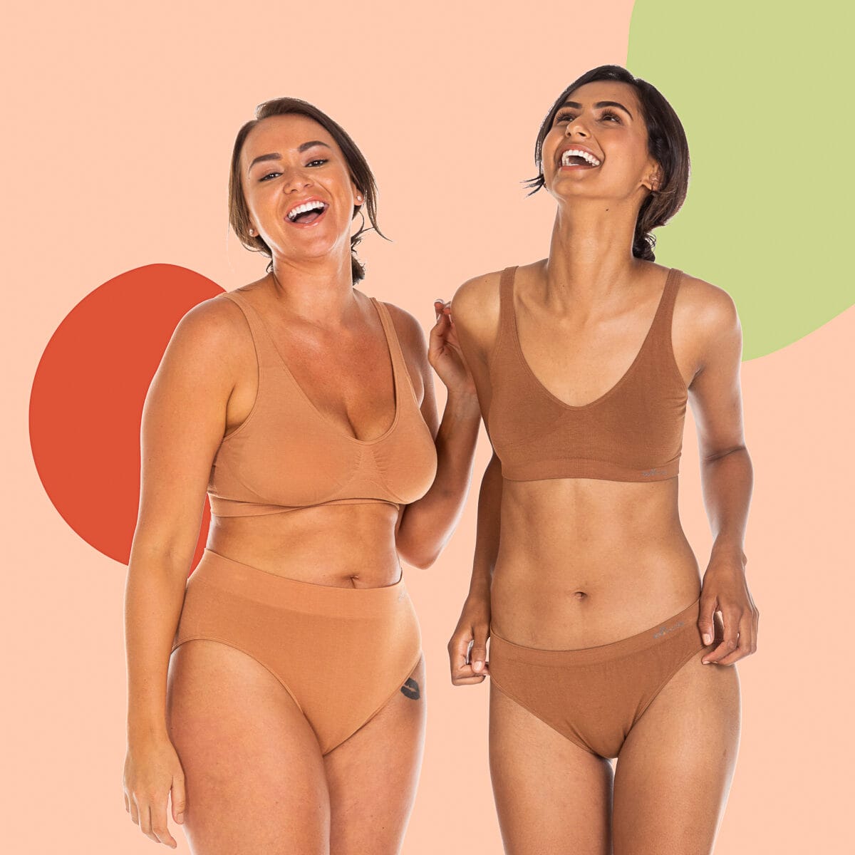 Naturally You post: two of the cast laughing on a peach ground