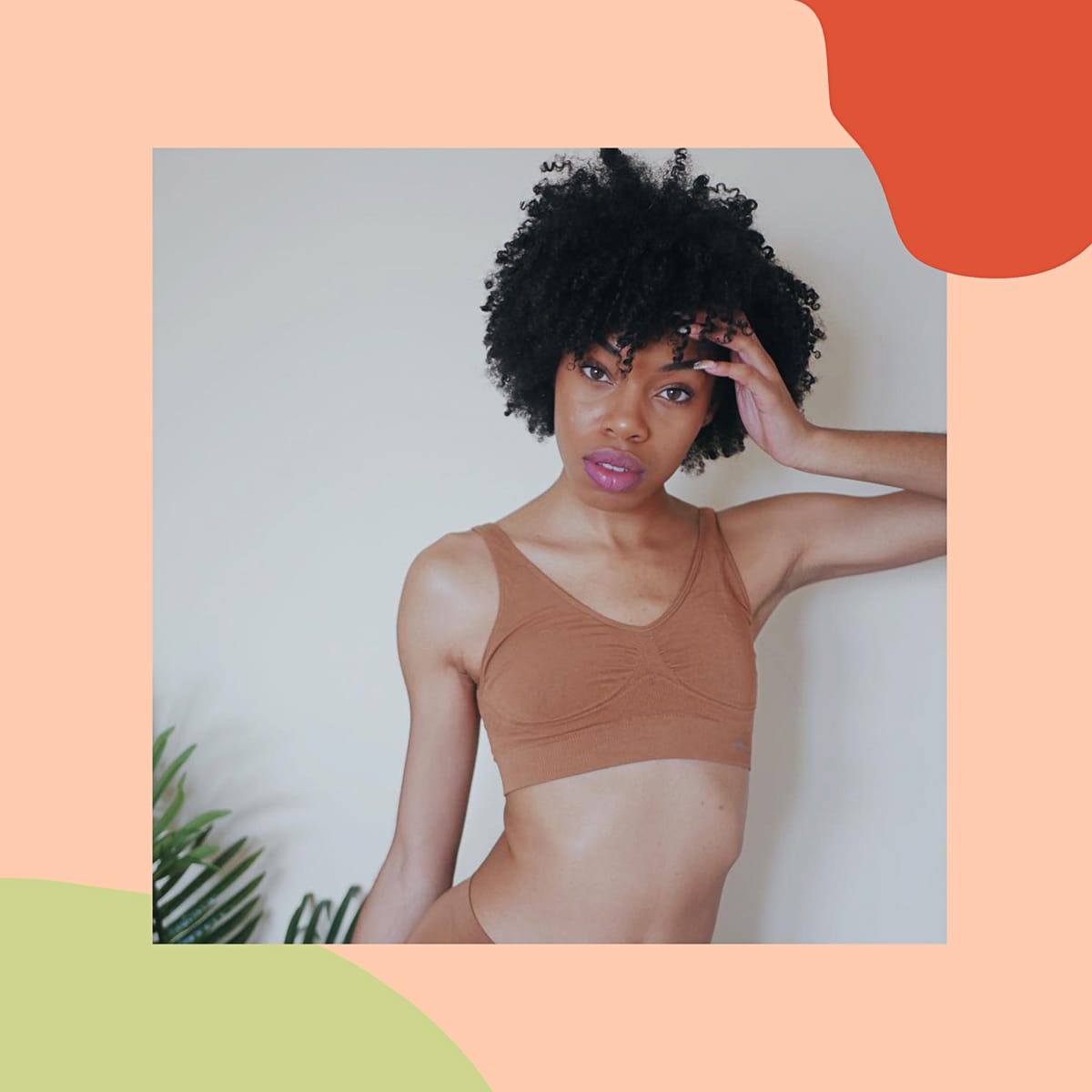Creator photograph framed on coral: a woman in a tan Boody bra and brief