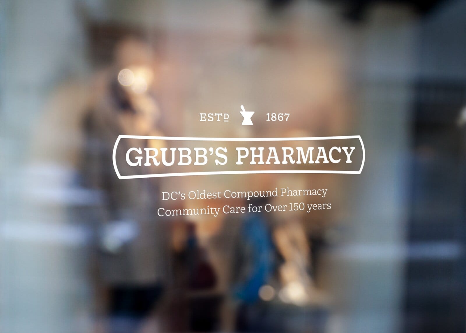 Grubb's Pharmacy keystone-framed name as window vinyl: EST. 1867, DC's oldest compound pharmacy