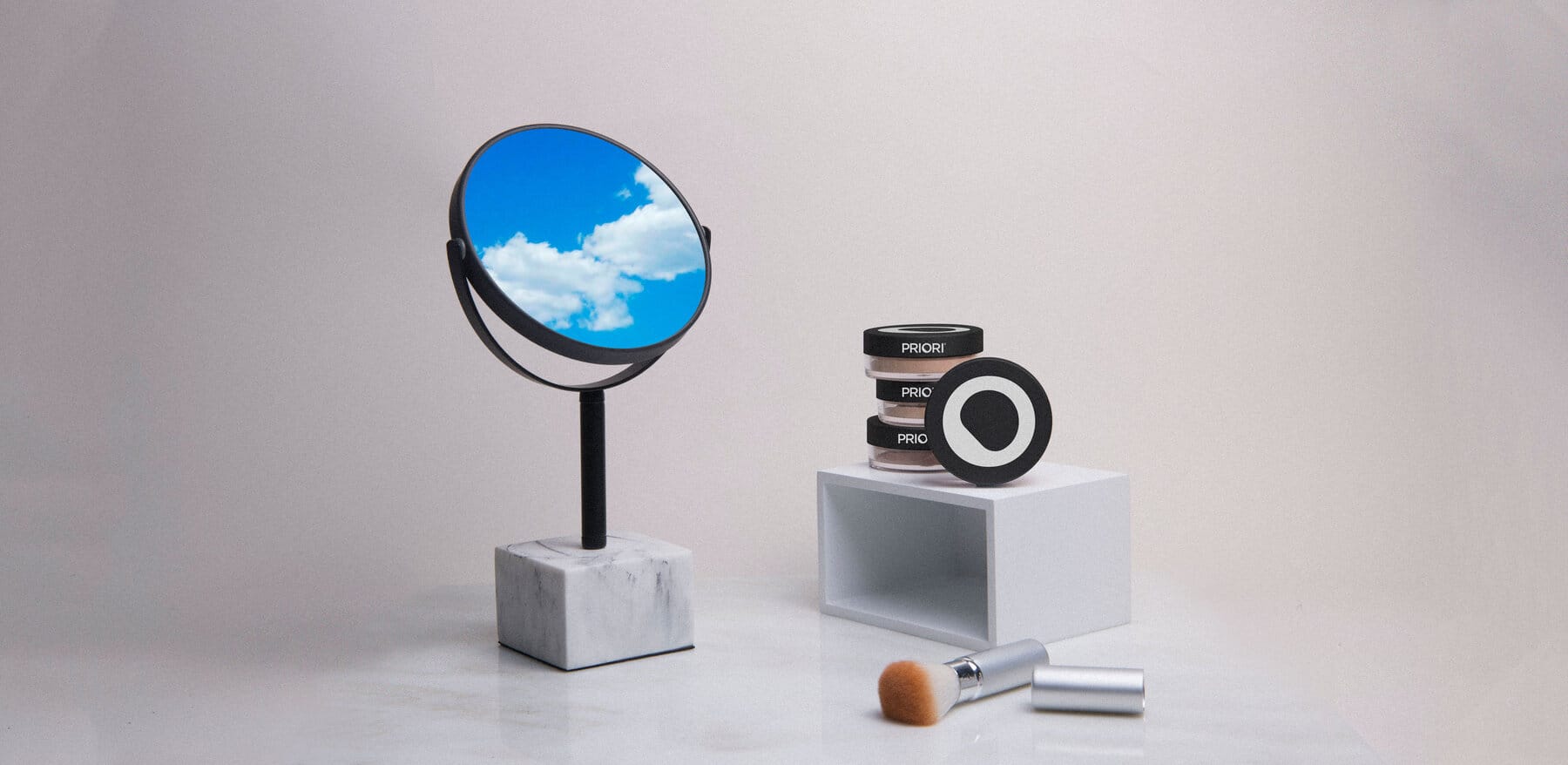 Still life with a sky-filled mirror on a marble block and Priori powder jars