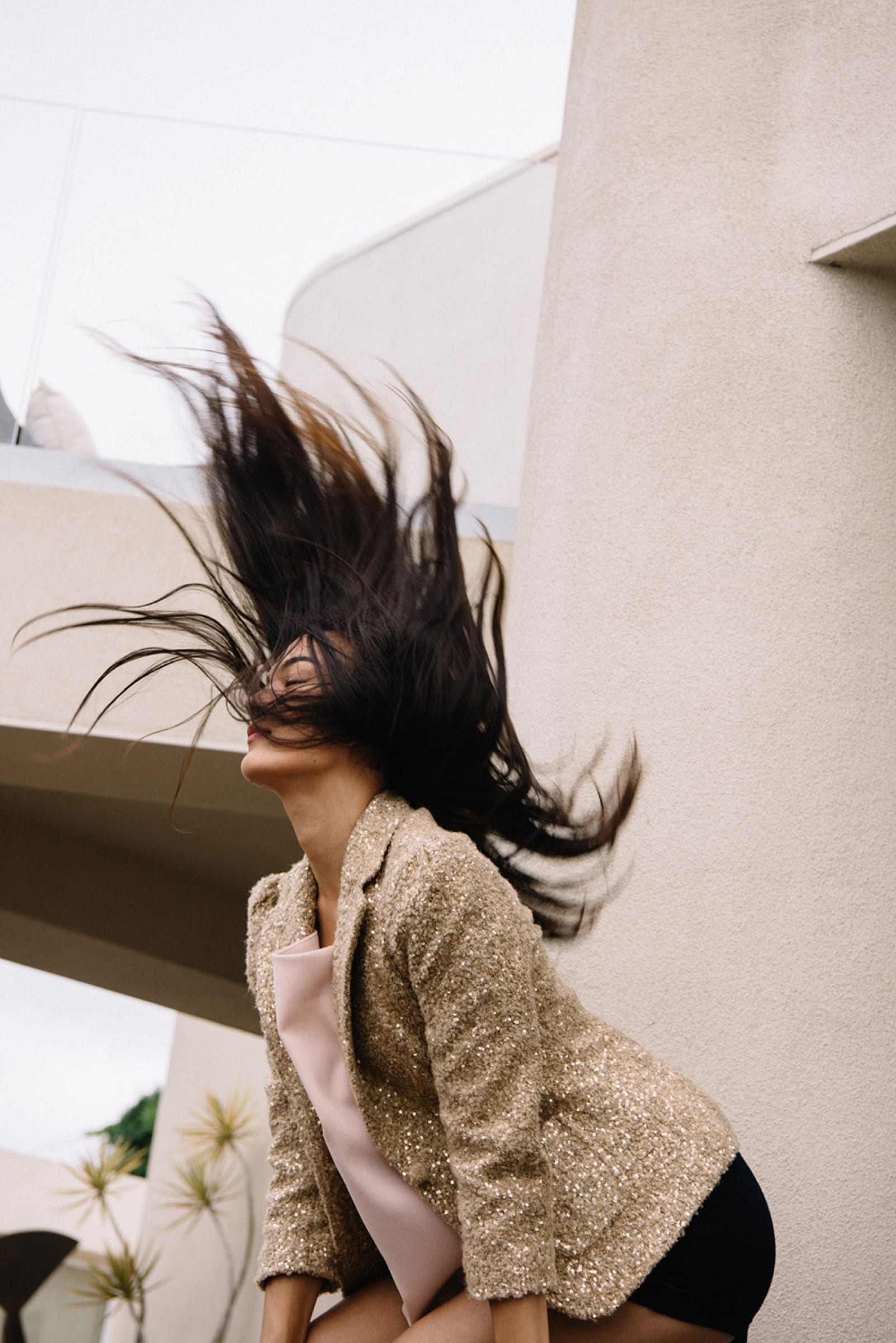 Woman flinging her hair on white stairs