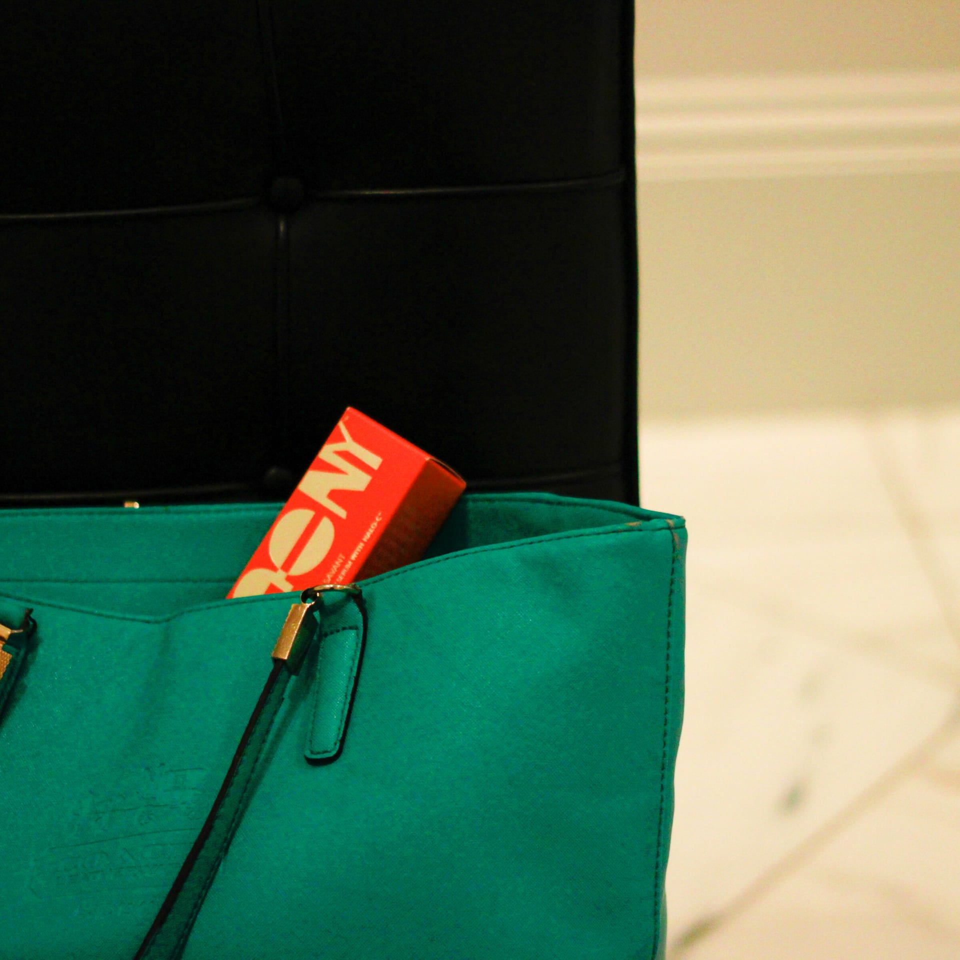 Serum Savant box tucked into a green leather bag