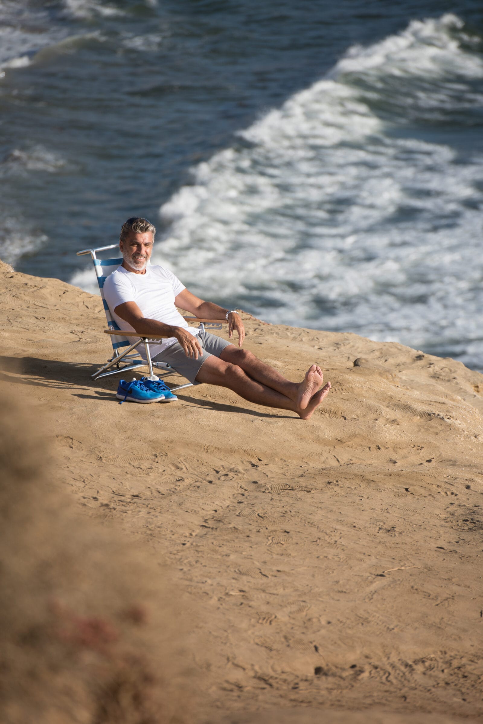 One of the cast seated on the sand after the shoot