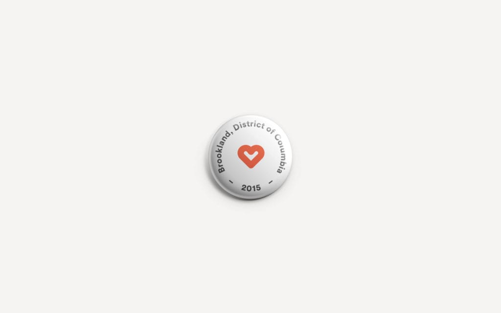 Brookland pin-board takeaway card variant with the badge mark and a secondary tagline