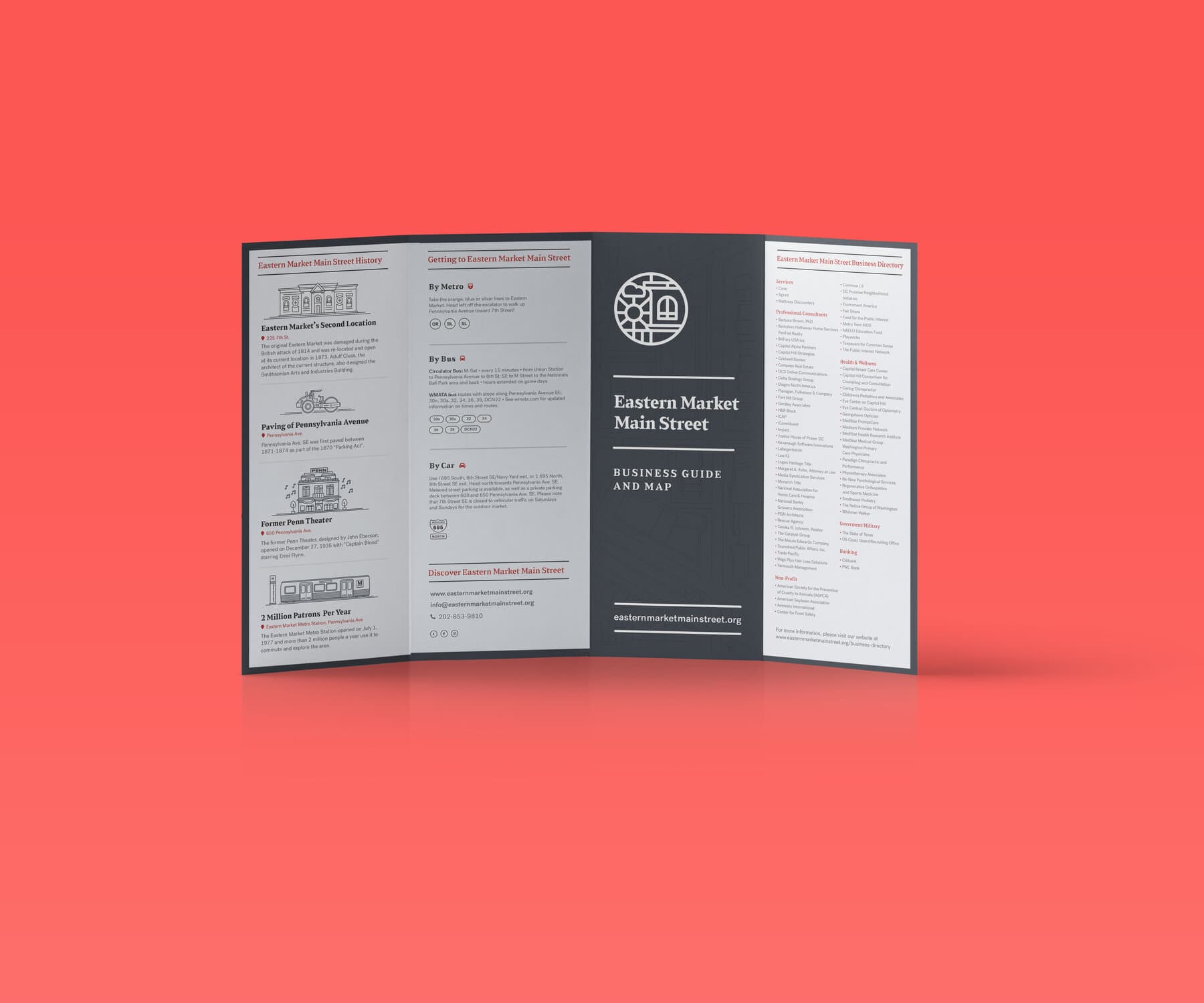 The tri-fold business guide open, charcoal panels with the medallion