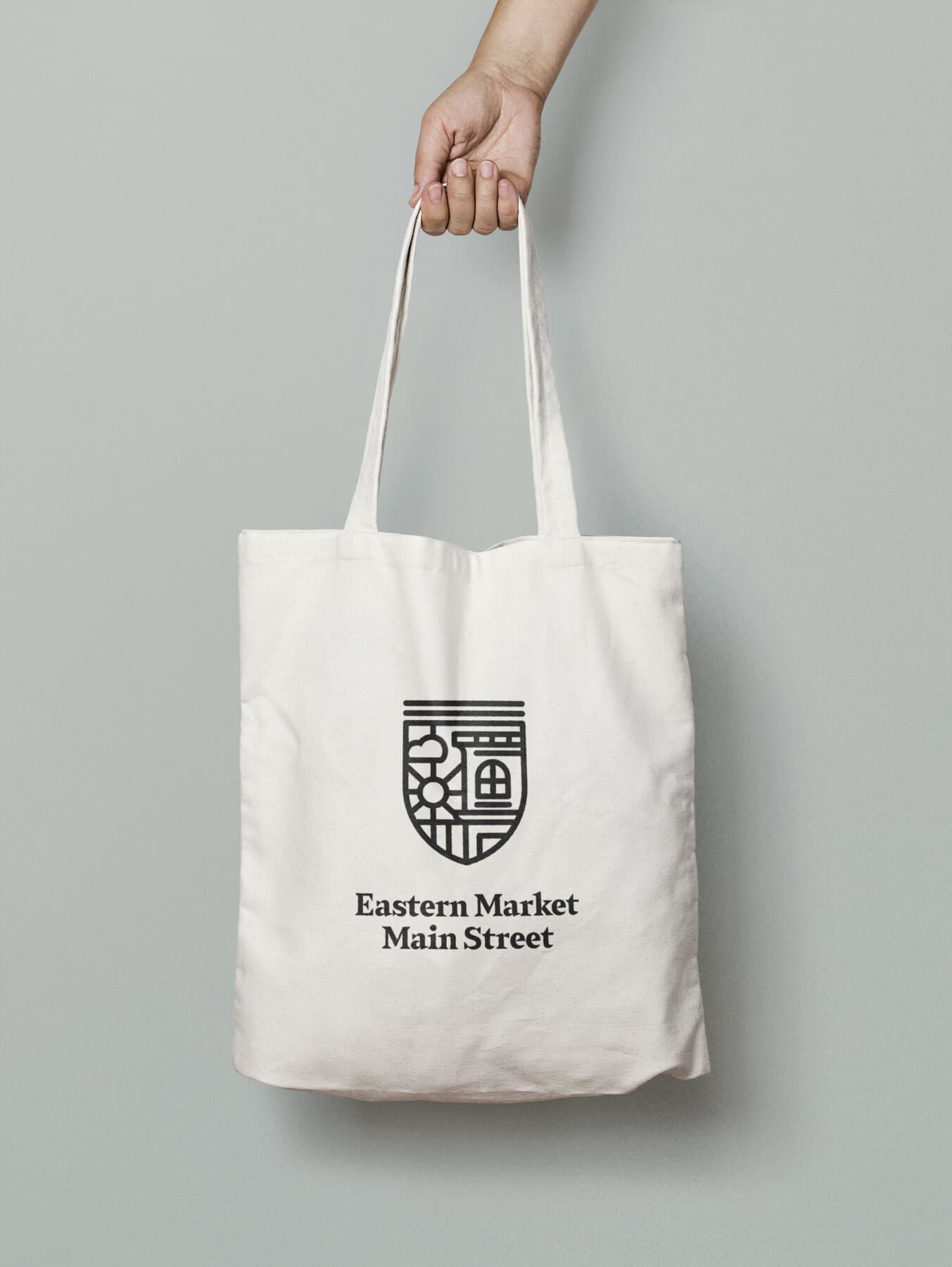 Cream canvas tote with the medallion mark