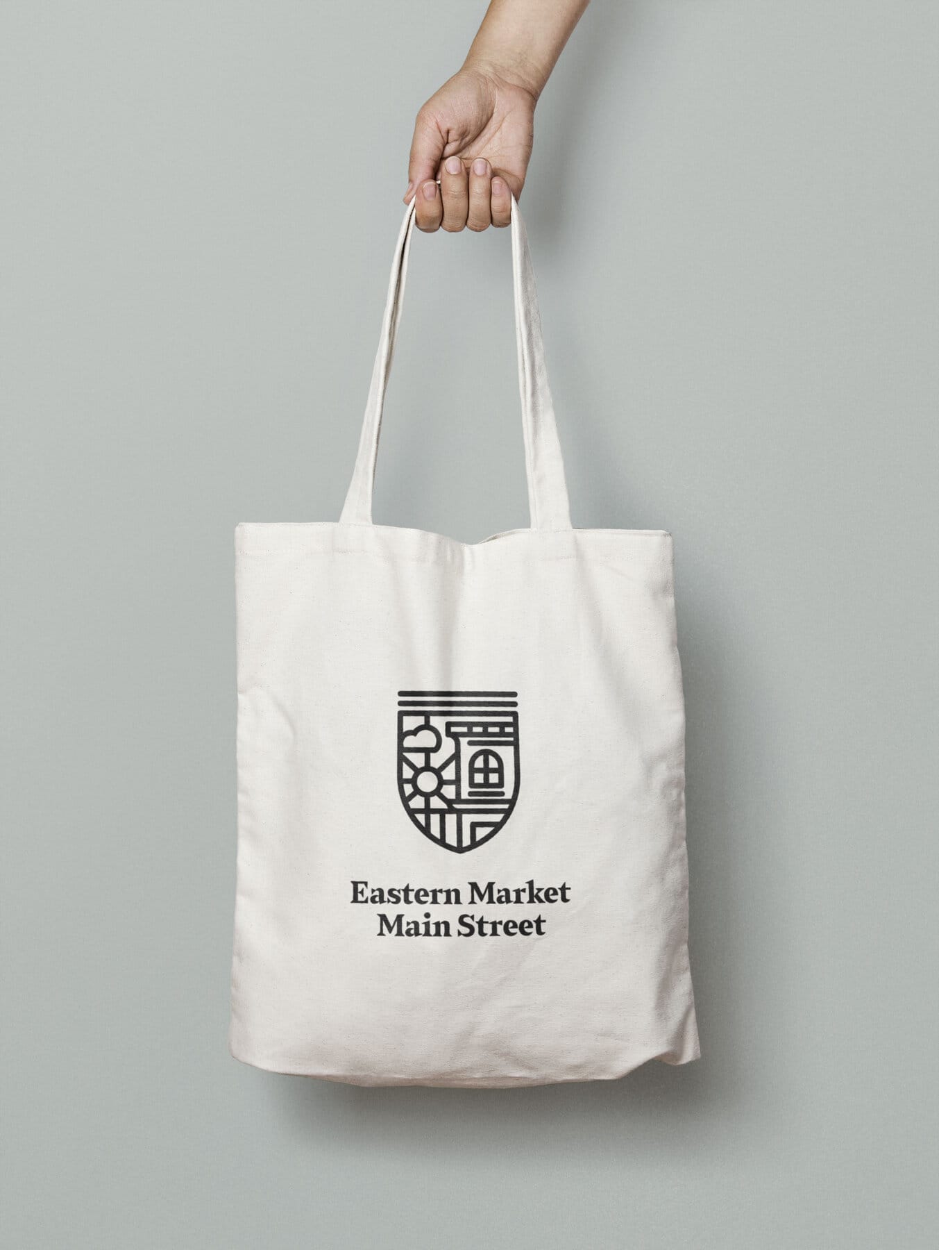 Cream canvas tote with the medallion mark