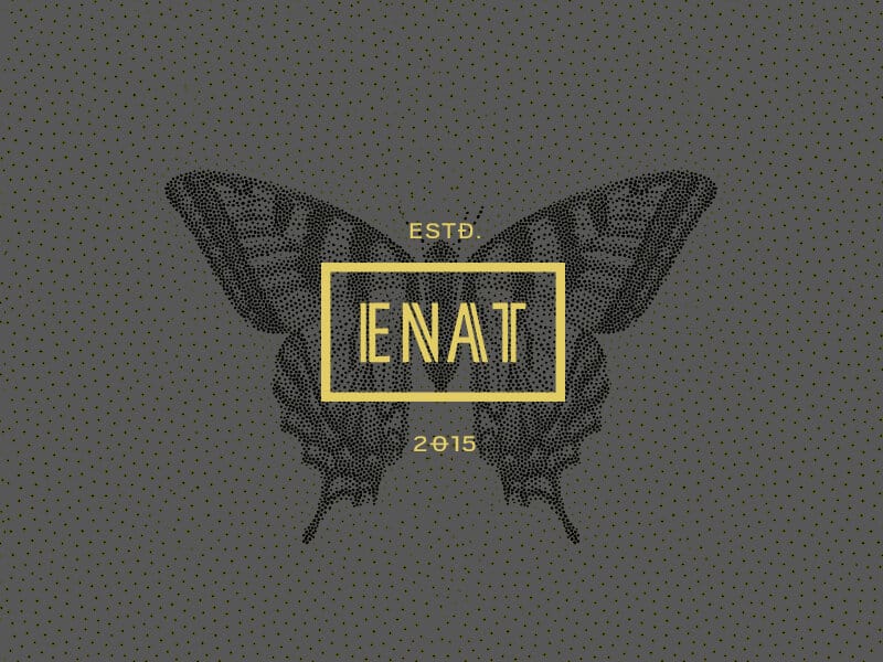 ENAT butterfly mark, ESTD 2015, on a dark dotted ground