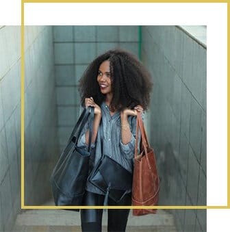 Model carrying Enat leather bags, gold-framed
