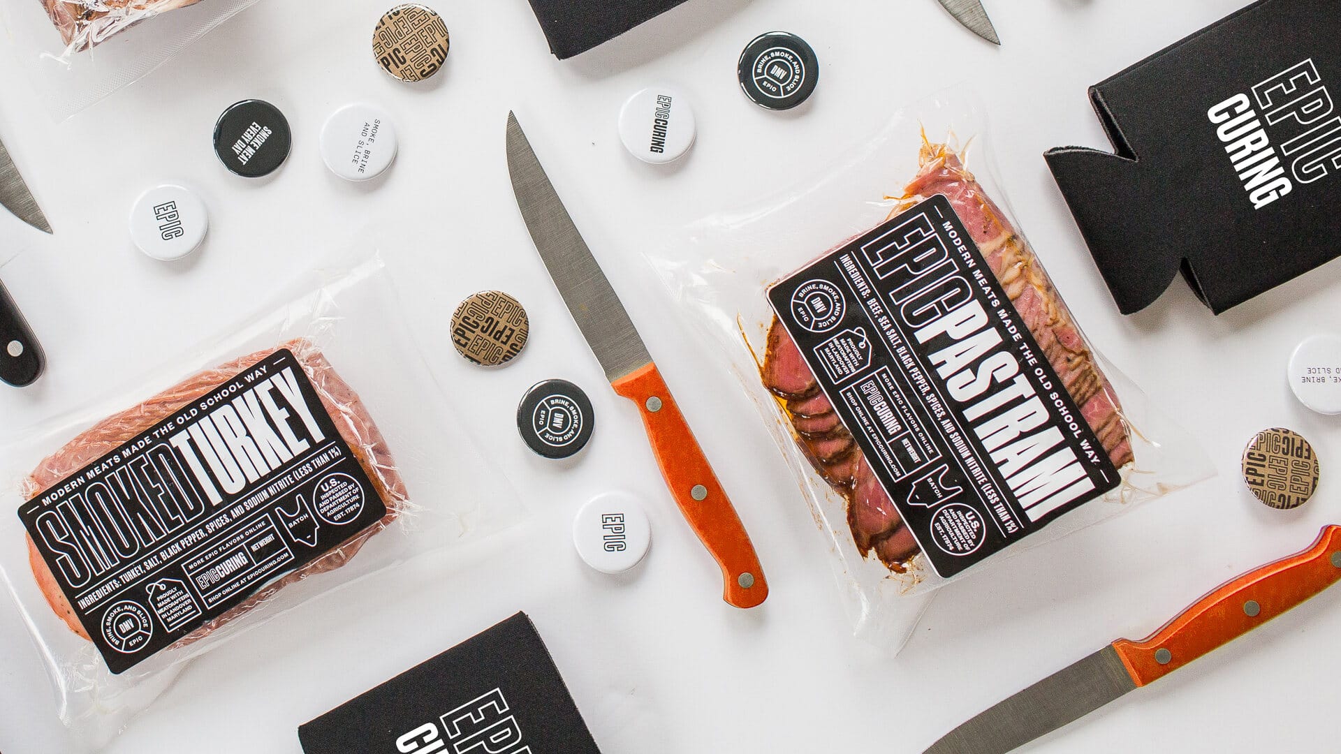 Epic Curing product line flatlay: labeled packs, knives, and brand tags on white