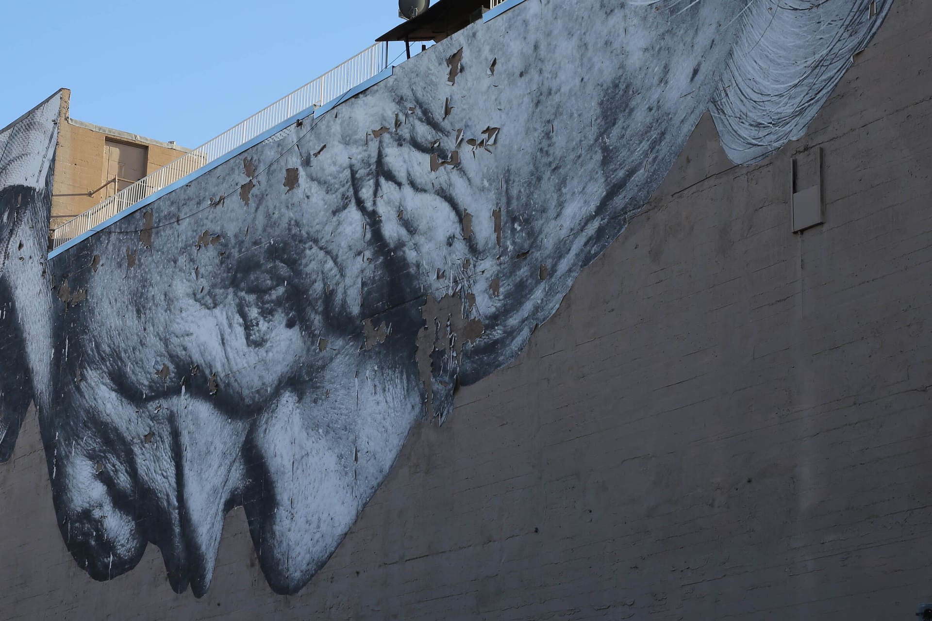 Weathered concrete wall with a pasted figure