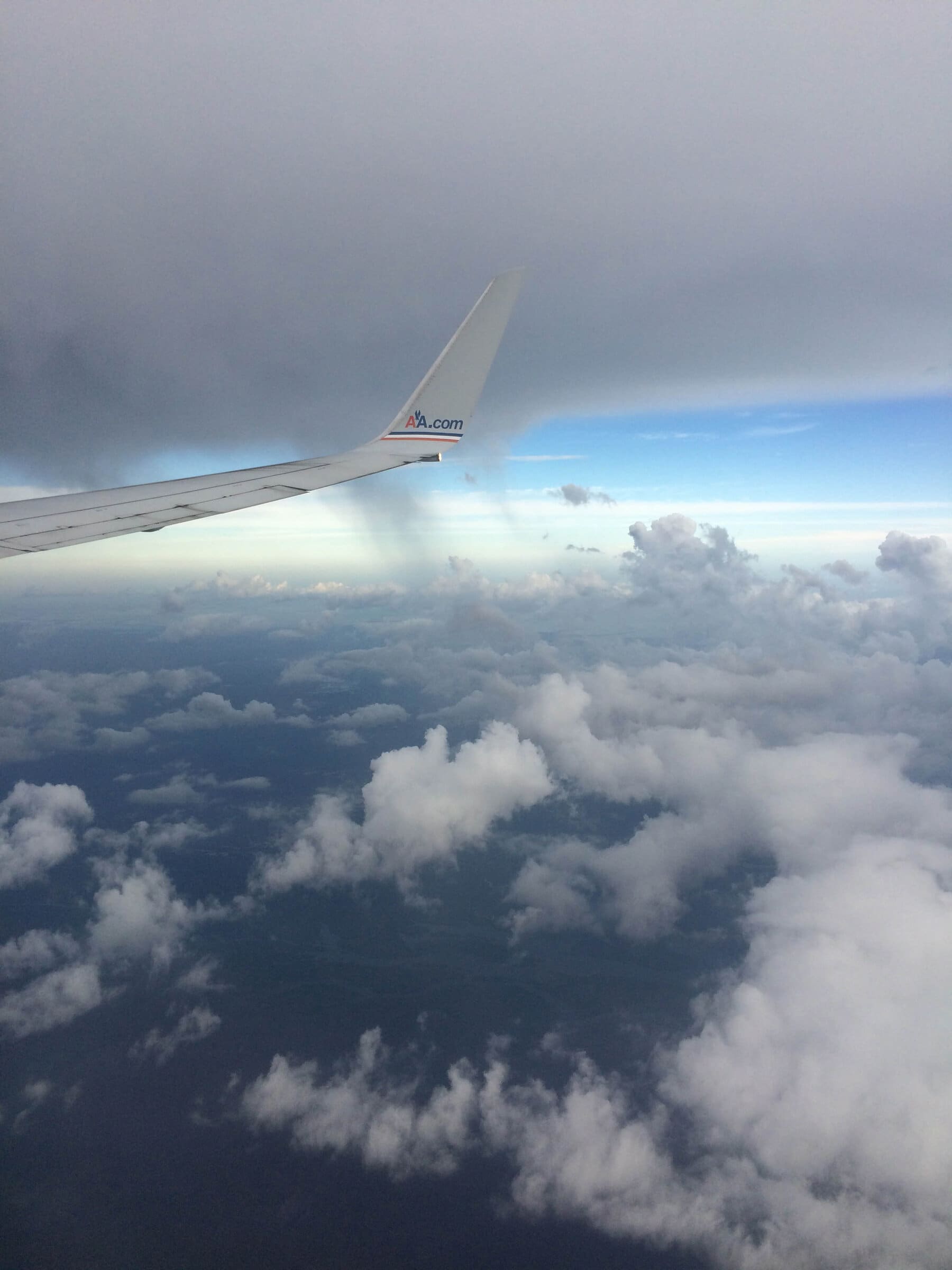 Airplane wing over clouds